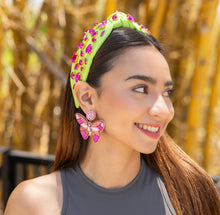 Load image into Gallery viewer,  Close-up of a woman's stylish headband adorned with jewels and butterfly-shaped earrings.
