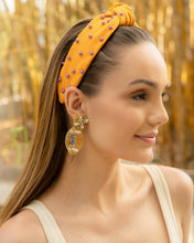 Load image into Gallery viewer, A vibrant yellow headband with beaded football details worn by a model.
