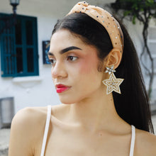 Load image into Gallery viewer, Close-up of a woman showcasing her star-shaped earrings and a fashionable headband.
