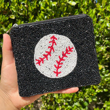 Load image into Gallery viewer, A hand holding a black coin purse with a baseball and stitching design, featuring a zipper closure.