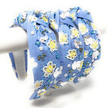 Load image into Gallery viewer, Chic spring-inspired knot headband adorned with white and yellow flowers, sparkling beads, and iridescent sequins.