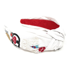 Load image into Gallery viewer, White nurse-themed headband with embroidered medical icons and playful red heart accents styled outdoors.