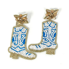 Load image into Gallery viewer, Close-up portrait featuring western-inspired boot earrings in blue and white beadwork paired with a chic off-the-shoulder top.