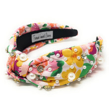 Load image into Gallery viewer, Woman wearing a colorful floral embellished headband with pearl accents and white flower statement earrings outdoors.