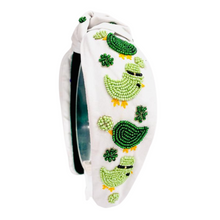 Load image into Gallery viewer, headbands for women, green knotted headband, headband style, top knot headband, green top knot headband, lucky charm headband, lucky charm hair band, green knot headband, top knotted headband, St Patrick’s headband, handmade headbands, top knotted headband, hand bead knotted headband, Clover leaf hair band for women, Hand bead St. Patrick’s headband, statement headbands, embellished headband, chic headband, clover leaf knot headband, st paddy’s headband, green hair accessories, four leaf clover headband