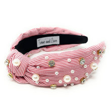 Load image into Gallery viewer, Pink striped knotted headband decorated with pearls and crystal accents for a playful and feminine statement look.