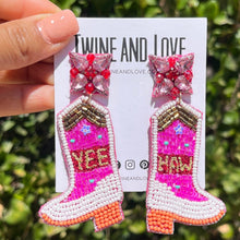 Load image into Gallery viewer, Pink cowboy boot earrings featuring colorful beadwork, crystal flower studs, and embroidered “Yee Haw” details.